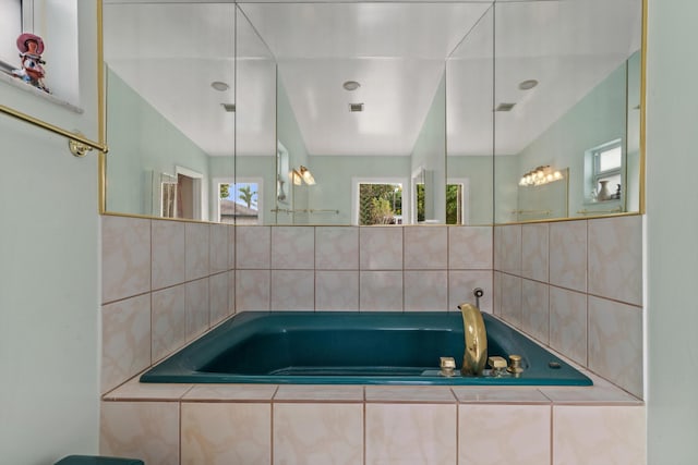 bathroom featuring a relaxing tiled tub