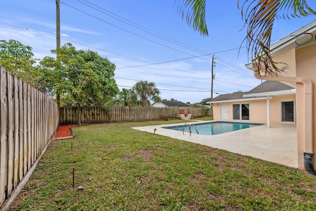 view of yard with a fenced in pool and a patio area