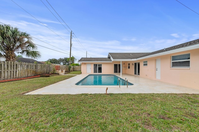 view of pool with a patio area and a yard