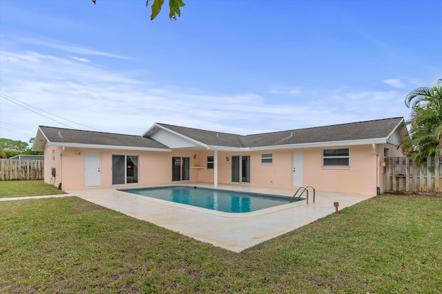 view of swimming pool featuring a lawn and a patio