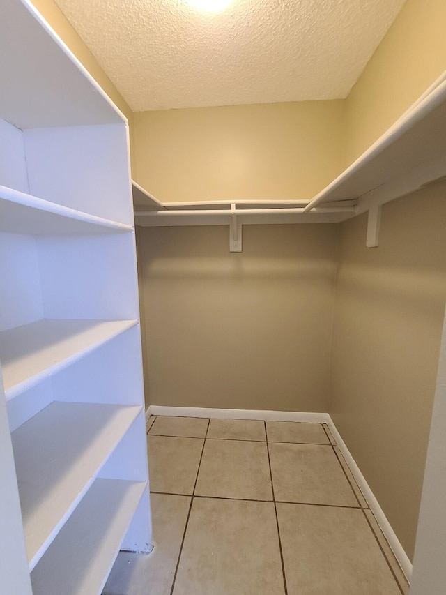 spacious closet with tile patterned flooring