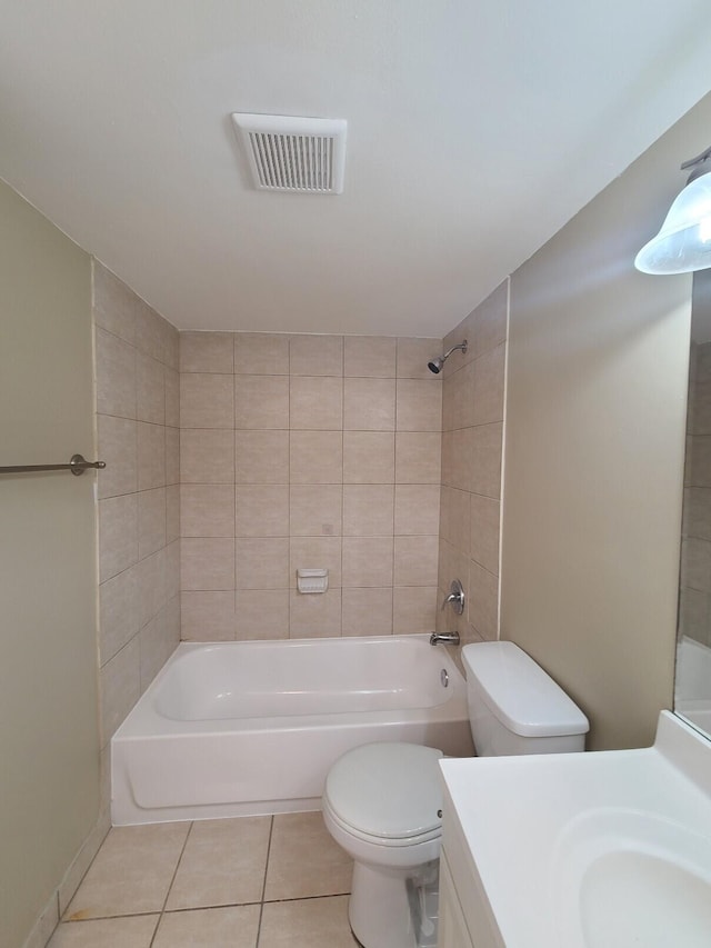 full bathroom featuring toilet, vanity, tile patterned floors, and tiled shower / bath