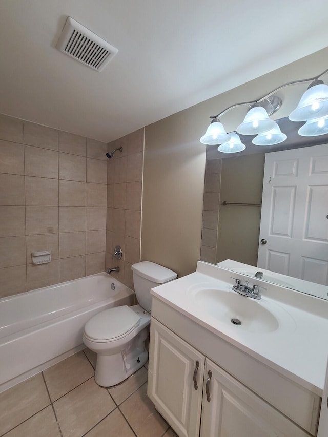 full bathroom featuring tile patterned floors, vanity, tiled shower / bath combo, and toilet