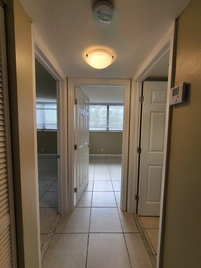 corridor featuring light tile patterned floors