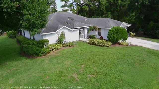 ranch-style house with a front lawn