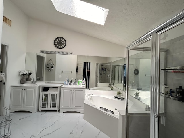 bathroom with a textured ceiling, vanity, lofted ceiling with skylight, and independent shower and bath