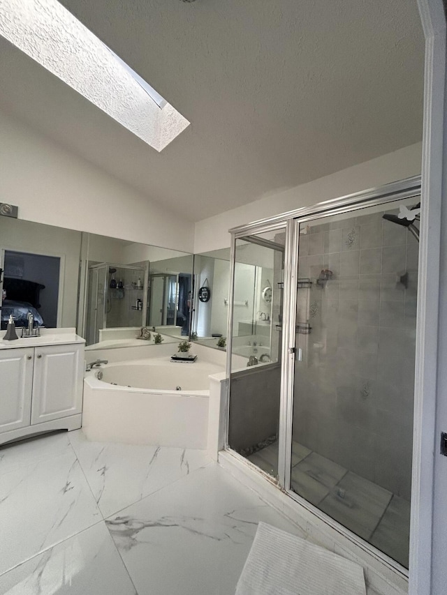 bathroom featuring vanity, lofted ceiling with skylight, and independent shower and bath