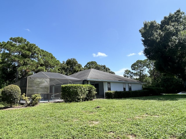 view of front facade with a front yard and a lanai