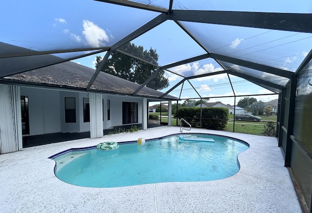 view of swimming pool with a patio area and a lanai