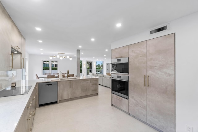 kitchen featuring appliances with stainless steel finishes, light brown cabinets, and sink