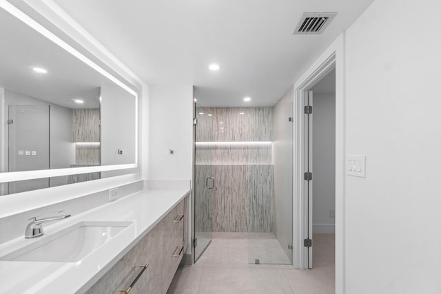 bathroom featuring vanity, tile patterned floors, and a shower with shower door