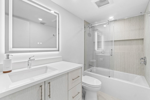 full bathroom with vanity, toilet, and shower / bath combination with glass door