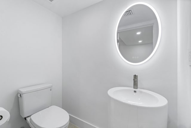 bathroom featuring sink and toilet