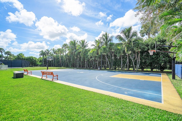 view of basketball court with a yard