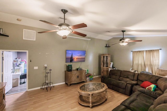 living room with light hardwood / wood-style floors, ceiling fan, and vaulted ceiling