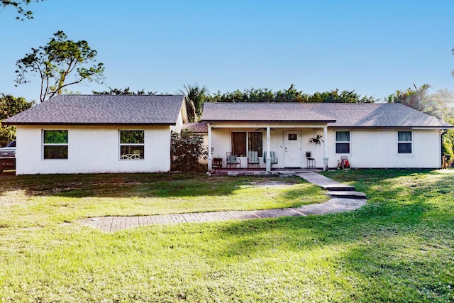 ranch-style house with a front yard and covered porch