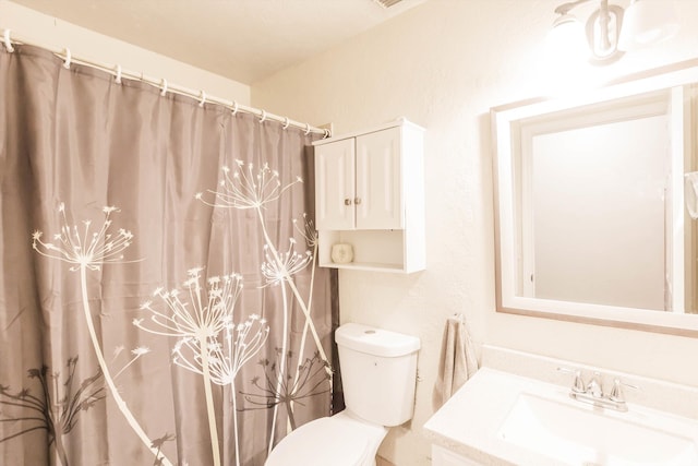 bathroom with toilet and vanity