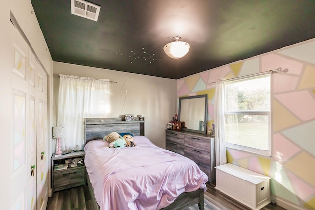 bedroom featuring a closet and hardwood / wood-style flooring