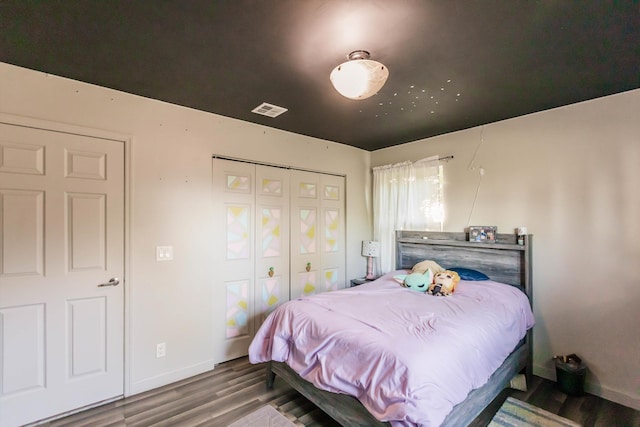 bedroom featuring wood-type flooring and a closet