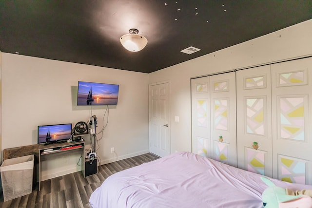 bedroom featuring a closet and dark hardwood / wood-style floors