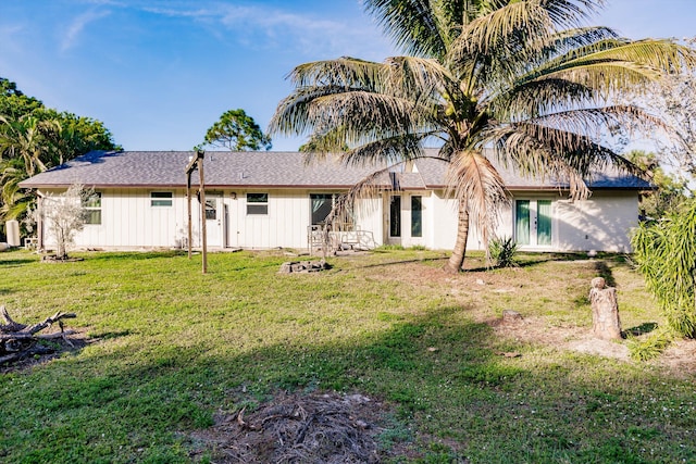 rear view of property featuring a yard