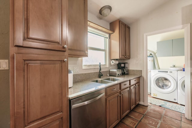 kitchen featuring stainless steel dishwasher, sink, and separate washer and dryer