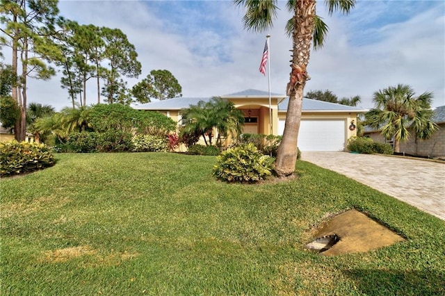 view of front of home featuring a garage and a front lawn