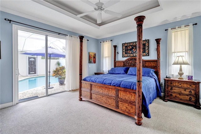 bedroom featuring carpet, ceiling fan, access to exterior, ornamental molding, and a tray ceiling