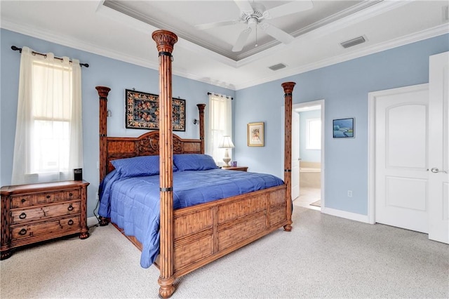 bedroom featuring ensuite bathroom, a raised ceiling, ceiling fan, and ornamental molding