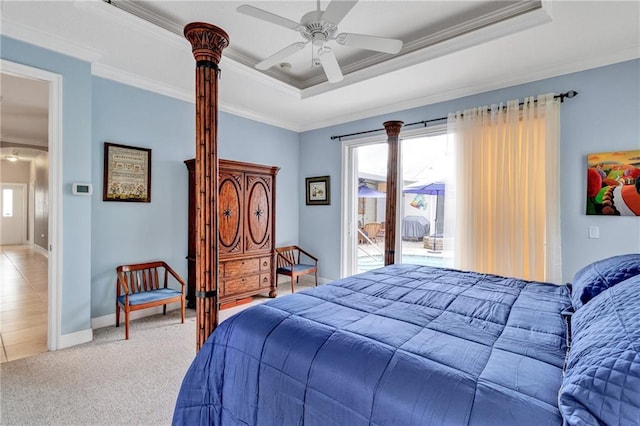 carpeted bedroom with ceiling fan, crown molding, and a tray ceiling