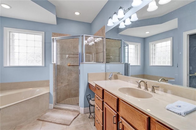 bathroom with vanity, tile patterned flooring, and plus walk in shower