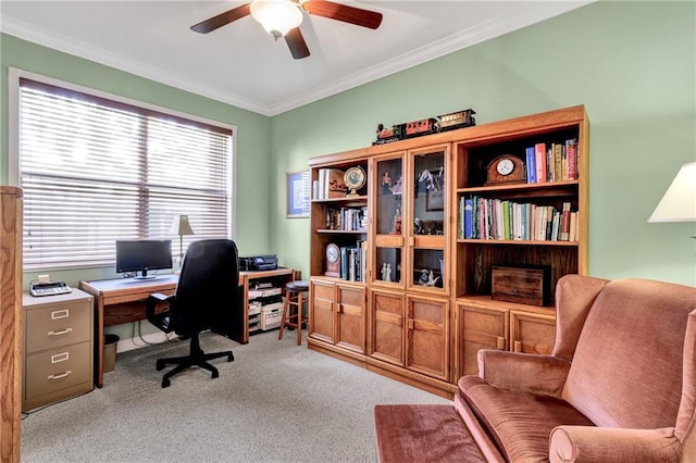 home office featuring light carpet, ceiling fan, and crown molding