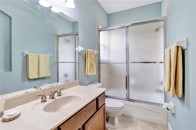 full bathroom featuring tile patterned flooring, toilet, vanity, and combined bath / shower with glass door