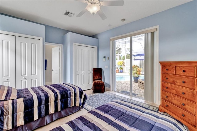 bedroom featuring access to outside, ceiling fan, light tile patterned flooring, and two closets