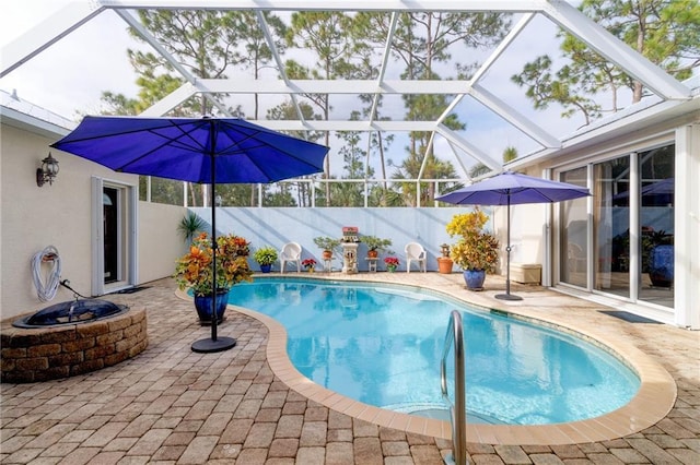 view of pool with a lanai and a patio