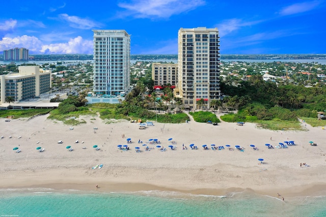 drone / aerial view featuring a view of the beach and a water view