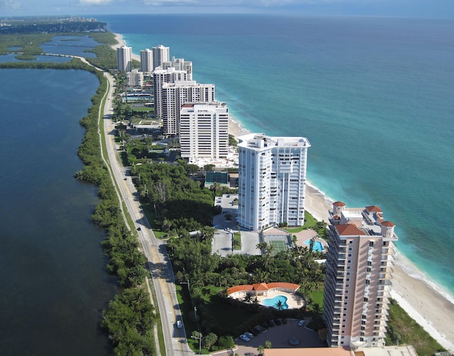 bird's eye view featuring a water view and a beach view