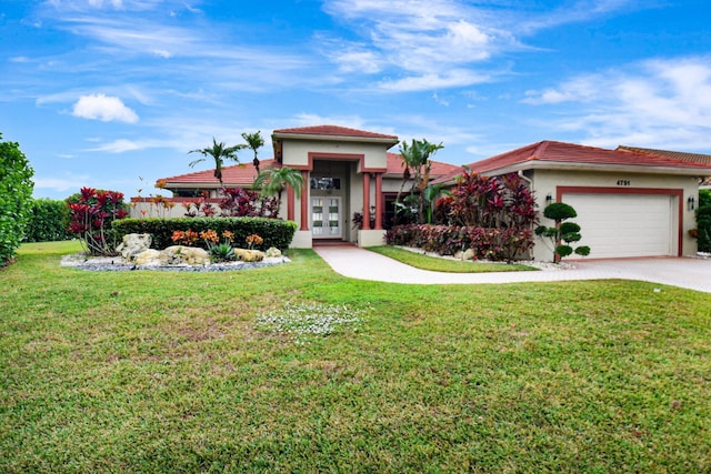 view of front of house with a front yard, french doors, and a garage