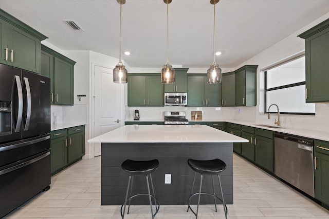 kitchen with green cabinets, appliances with stainless steel finishes, and sink