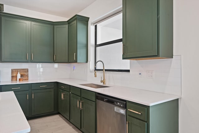 kitchen with sink, stainless steel dishwasher, and green cabinetry