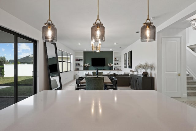 kitchen featuring hanging light fixtures and built in shelves