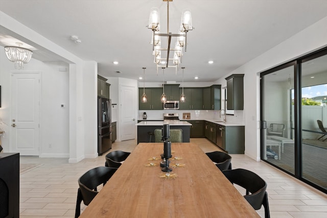 dining area with an inviting chandelier and sink