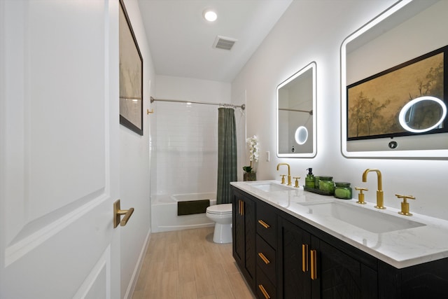 full bathroom featuring toilet, vanity, shower / bathtub combination with curtain, and hardwood / wood-style floors