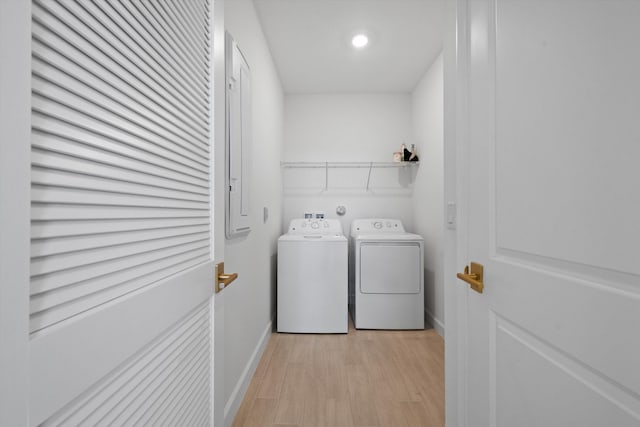 laundry room with washer and dryer and light wood-type flooring