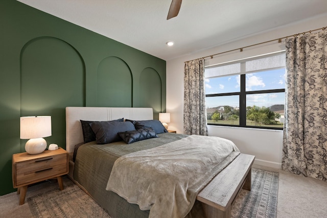 bedroom featuring ceiling fan and carpet