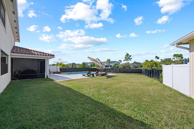 view of yard featuring a fenced in pool and a sunroom