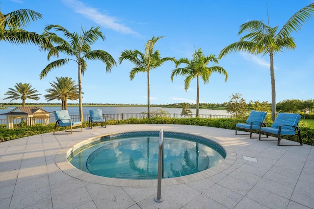 view of swimming pool with a patio area and an in ground hot tub