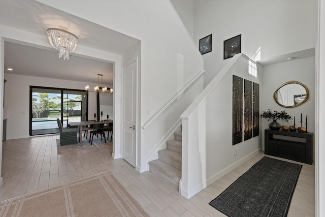 foyer featuring an inviting chandelier and light hardwood / wood-style flooring