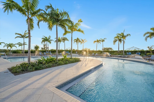 view of swimming pool with pool water feature