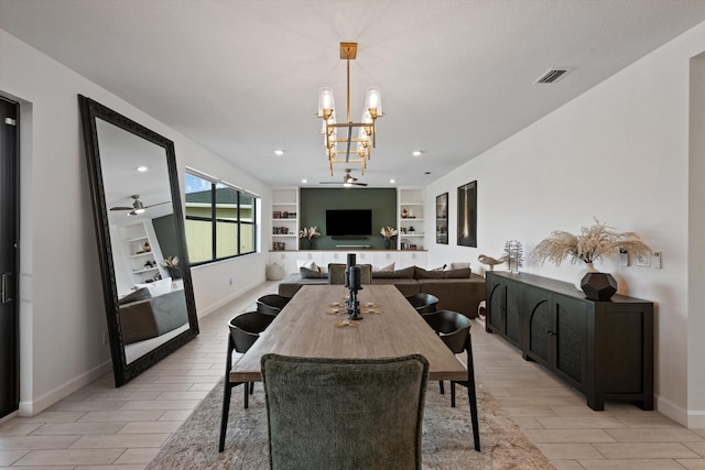 dining space featuring ceiling fan with notable chandelier and built in features